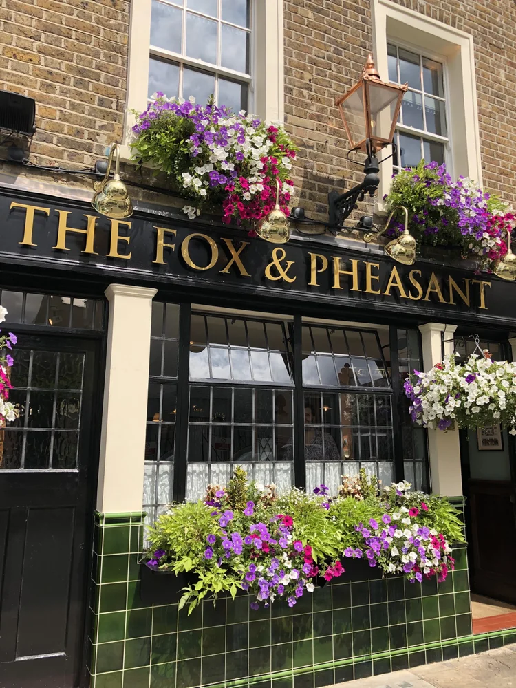 The Fox & Pheasant exterior with flowers